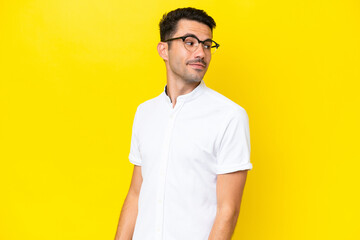 Young handsome man over isolated yellow background . Portrait