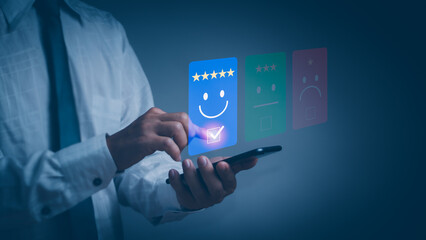 concept of satisfaction survey and customer service ,man using  smartphone rating Satisfied with smiley face and star icon Show quality assessment Highest satisfaction from receiving great service