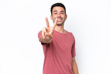 Young handsome man over isolated white background smiling and showing victory sign