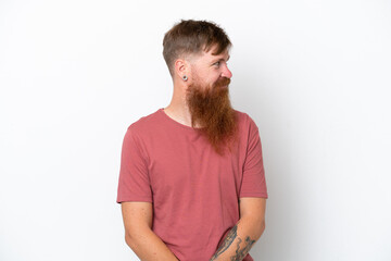 Obraz premium Redhead man with long beard isolated on white background looking to the side