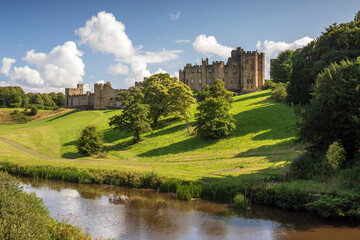 View of Alnwick Castle from the Lion Bridge over the River Aln in Northumberland, England.