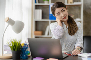 Asian businesswoman relaxing and happy at desk and stretching arms after work done. Relax, chill, take a break during work break.