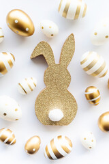 Cute easter bunny and golden eggs isolated on white background. Happy Easter minimal concept, greeting card. soft selective focus.