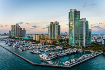 Marina in Miami Beach with the Miami skyline in the background at sunset with many boats