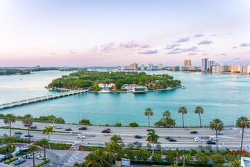 Island in the Miami Beach waterway with a bridge going out to it with the Miami skyline in the background