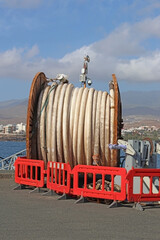 A large roll of pipe in a fishing port