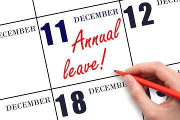 Hand writing the text ANNUAL LEAVE and drawing the sun on the calendar date December 11