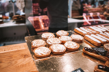 a display case filled with lots of different types of cakes and pies on display in a bakery or deli or bakery shop front view of cakes and frosted with frosting on the shelves. Selective Focus. High