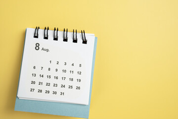 close up of calendar on the yellow table background, planning for business meeting or travel planning concept