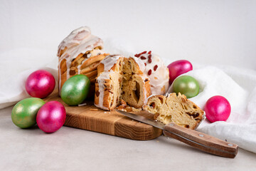 Easter cakes with white icing and a knife and colored eggs