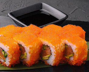 Sushi rolls philadelphia on a black slate