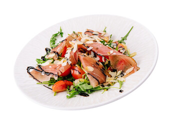 Salad with prosciutto, tomato, arugula leaves on plate