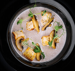 Creamy mushroom soup with champignons top view