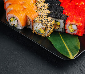 Big set of rolls on black tray