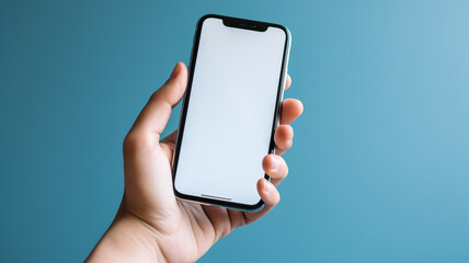 Human holding mobile phone with empty clean isolated blue background, mock up for product display or advertisement.