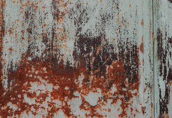 Rusty metal painted background. Rust spots and streaks on stained metal surface. Grunge industrial colored steel texture. Scratched corroded aged damaged backdrop with rustic vintage worn details.