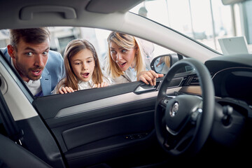 Surpised family watching new car