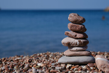 Balance stones close-up on the beach at summer sunny day