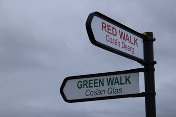 Trail signs in English and Irish Reading "RED WALK" and "GREEN WALK"