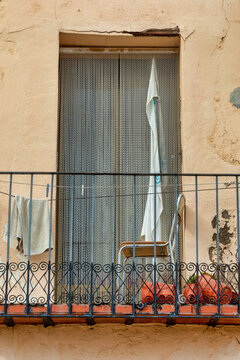 Cozy Spanish Balcony with Chair and Clothesline for Authentic Experience