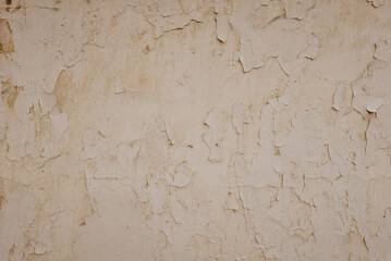 Weathered cracked plaster background. Damaged wall texture with peeling paint, shabby vintage rustic surface.