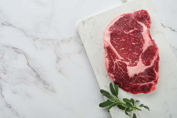 Raw fresh ribeye steak or Rib-eye steak. Raw fresh marbled meat Ribeye Black Angus and seasonings...