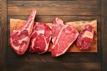 Raw prime steaks. Variety of fresh black angus prime meat steaks T-bone, New York, Ribeye,...