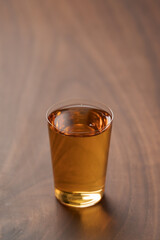 Organic apple cider in tumbler glass on wood table