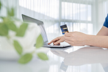 Woman Hands holding credit card and using laptop. Online shopping