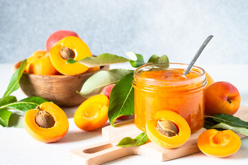 Apricot jam in glass jar with fresh apricots. Homemade preservations.