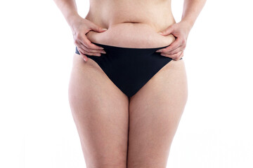 Fototapeta na wymiar Female body in black shorts with overweight and cellulite keeps belly fat. Close-up. Isolated on white background. Front view.