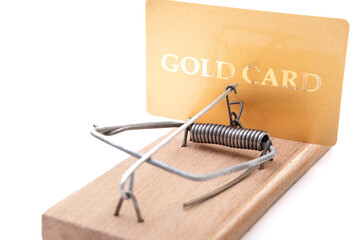 Gold credit card on a mousetrap, Financial trap, Debt, Financial problems.