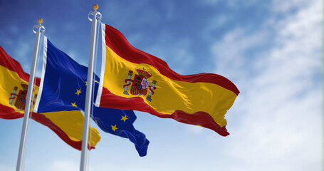 the flags of Spain and the European Union waving in the wind on a sunny day. Democracy and politics. European country.