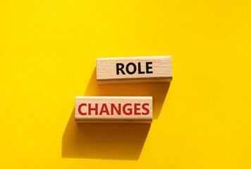 Role changes symbol. Concept words Role changes on wooden blocks. Beautiful yellow background. Business and Role changes concept. Copy space.