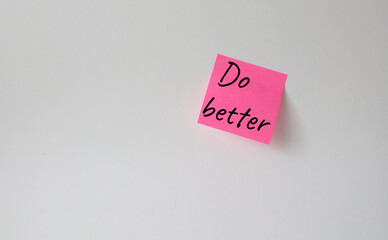 Do better symbol. Pink steaky note with concept words do better. Beautiful white background....