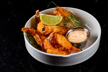 Whole fried big shrimps with seasonings in plate