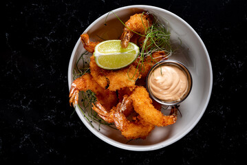 Whole fried big shrimps with seasonings in plate