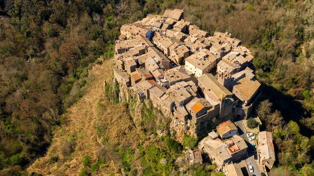 Aerial view of old town of Calcata, in the Province of Viterbo, Lazio, Italy. The town overlooking the valley of Treja. All houses have traditional red tiled roofs in the historical centre of Calcata.