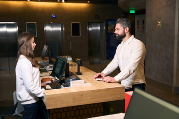 Businessman checking into hotel at front desk