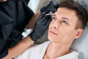 Male in beauty clinic getting injection procedures