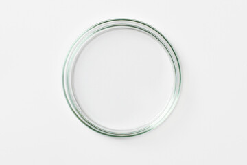 An empty petri dish on a light background.