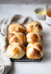Easter breakfast with traditional hot cross bun and apricot jam.	