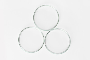 Three empty Petri dishes on a light background.