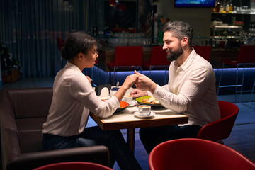 Romantic couple enjoying each other company at dinner
