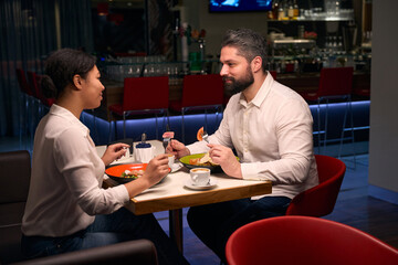 Romantic couple looking at each other over dinner