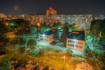 A yard inside the residential area block at night. Kyiv, Ukraine. Aerial view.
