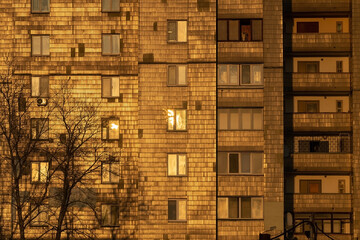 Old multi storey houses tiled by glazed tiles which looks like golden tiles under sunset lighting. Kyiv, Ukraine.
