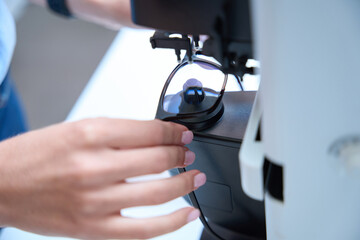 Fototapeta na wymiar Process installing lenses of frame in the optician clinic
