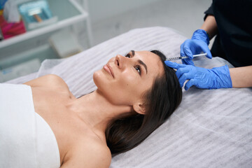 Obraz na płótnie Canvas Woman doing cosmetic procedures for face, skin nutrition