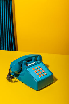 Retro phone on yellow desk